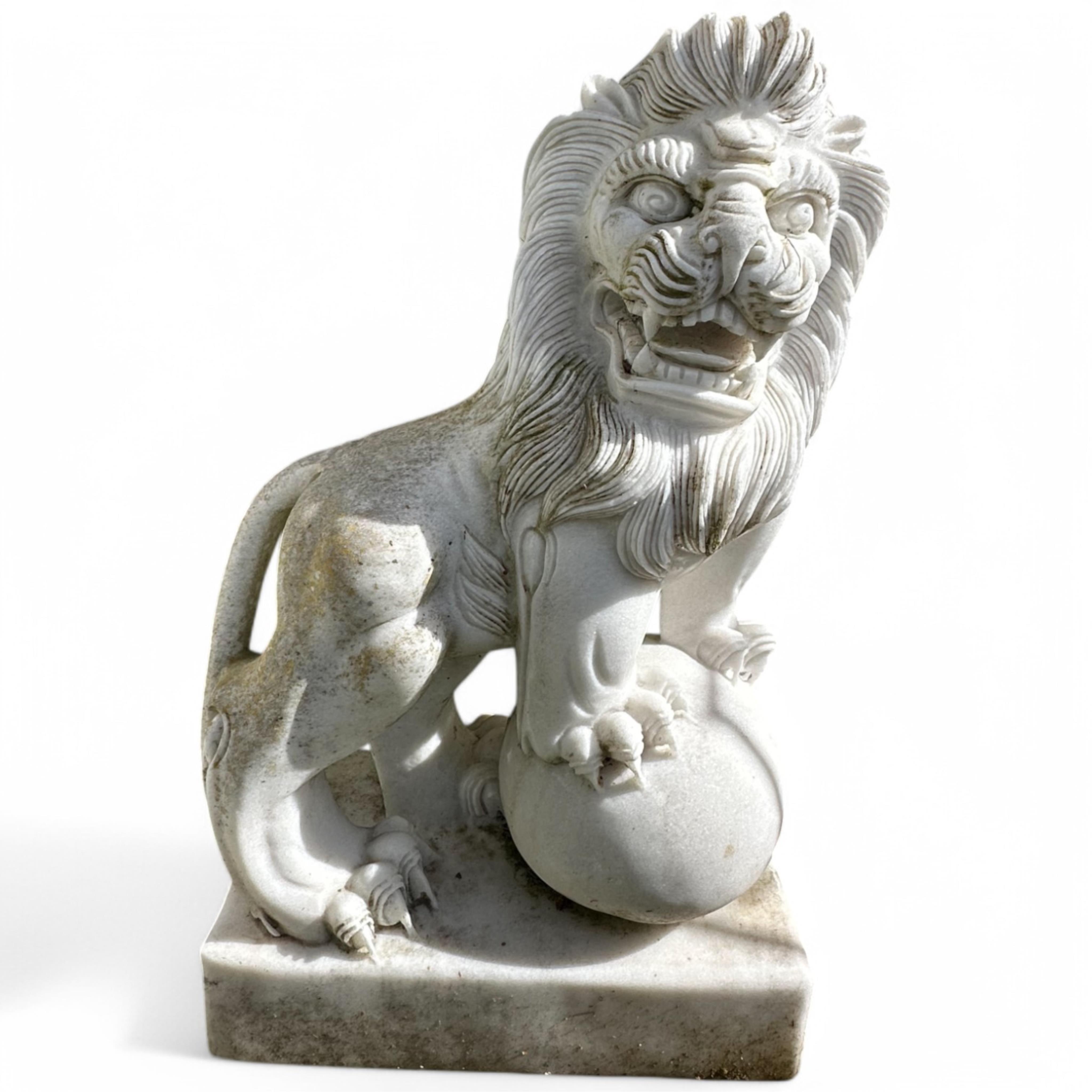 A pair of reconstituted white marble models of lions rampant